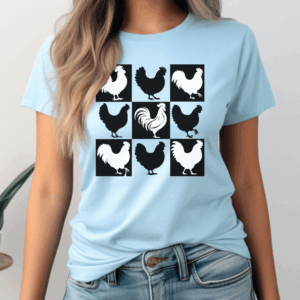 Woman wearing a light blue t-shirt with a grid design featuring nine square panels, each displaying a rooster silhouette. The pattern alternates between black roosters on white backgrounds and white roosters on black backgrounds. The woman is shown from the waist up, wearing light denim jeans against a plain neutral background.